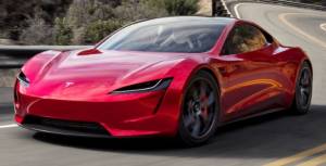 red tesla roadster on winding roads