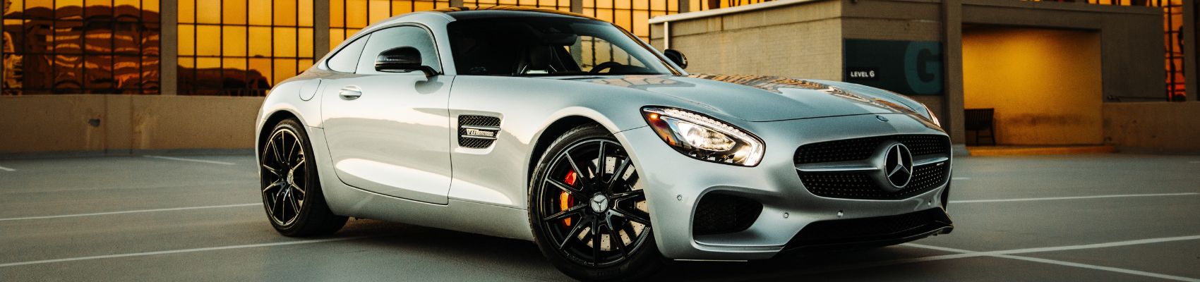 mercedes benz amg gt in white in front of skyscraper
