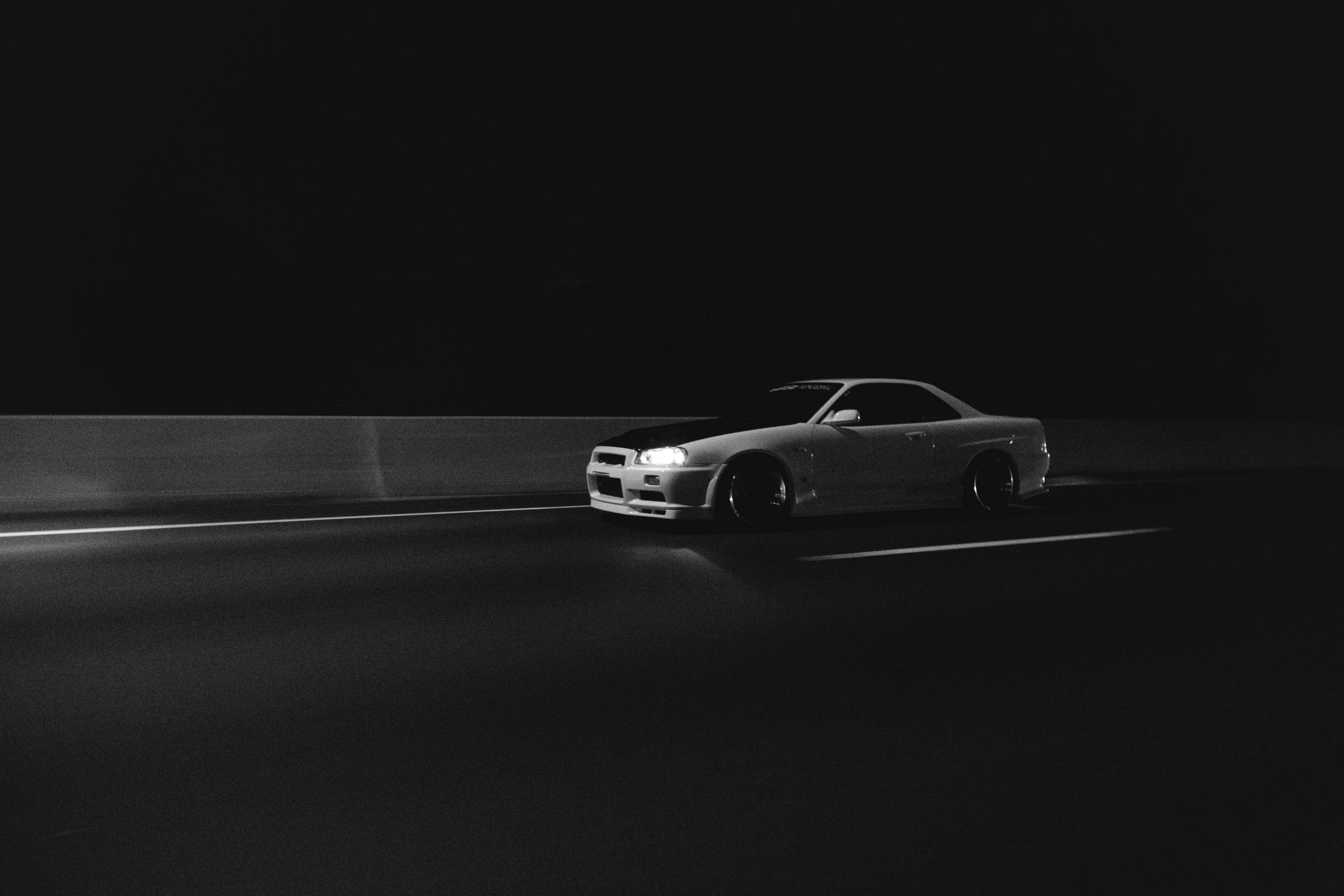 jdm r34 skyline at night in black and white