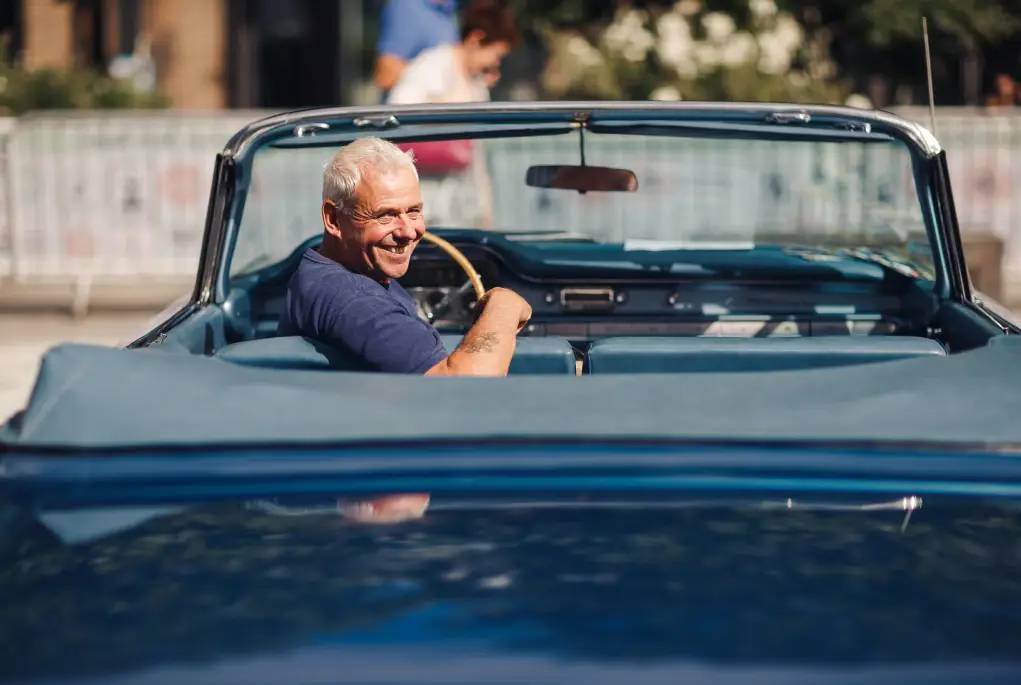 Classic car owner in convertible 