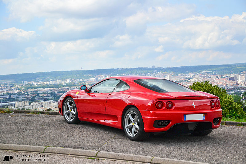 Ferrari moderna in red with city in the background, a candidate for Woodside's classic car loan program
