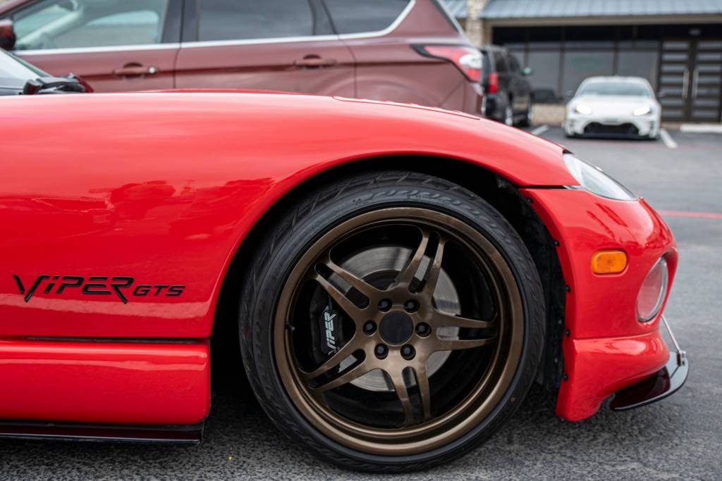 front rim of a 1990s dodge viper in red. 